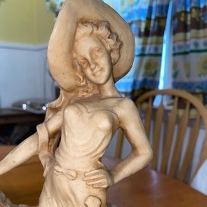 Vintage bone colored women walking her greyhounds. Very heavy